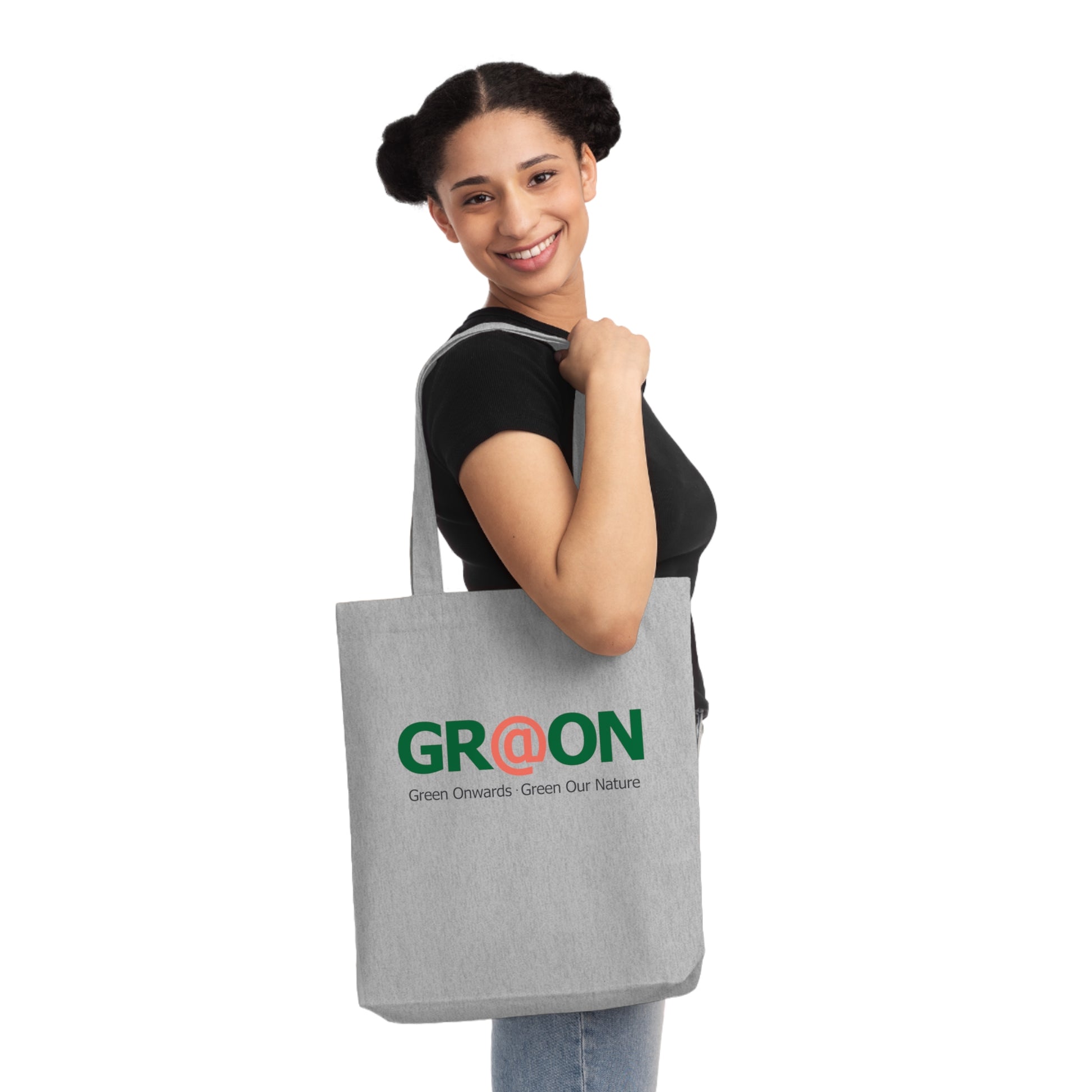 Person carrying a GR@ON Tote Bag made from organic cotton, filled with everyday essentials. GR@ON Tote Bags: Sustainable style, everyday essentials.