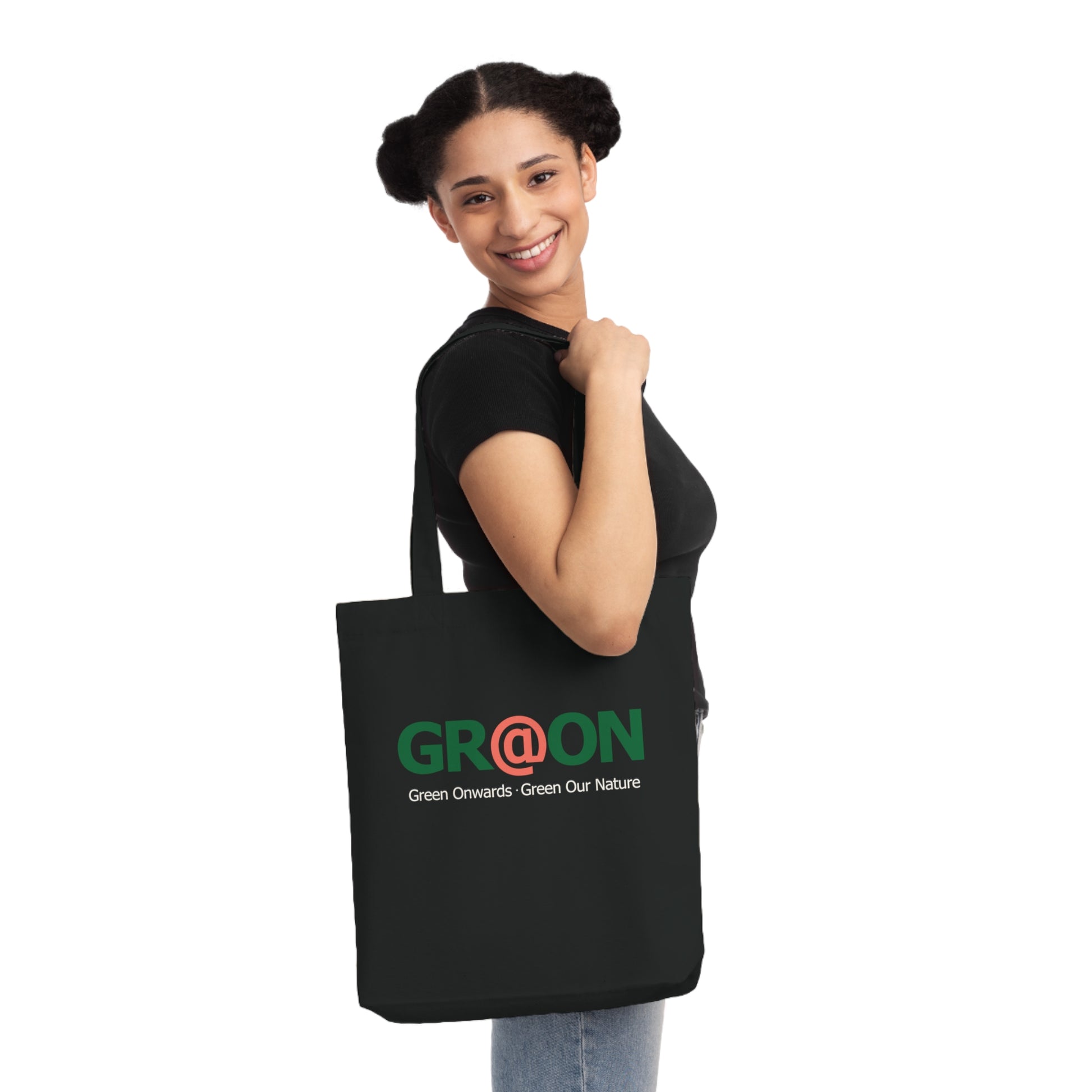 Person carrying a GR@ON Tote Bag made from organic cotton, filled with everyday essentials. GR@ON Tote Bags: Sustainable style, everyday essentials.