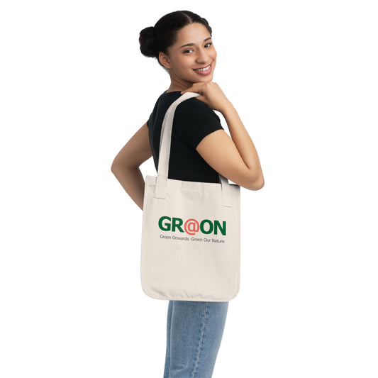 Person carrying a GR@ON Tote Bag made from organic cotton, filled with everyday essentials. GR@ON Tote Bags: Sustainable style, everyday essentials.