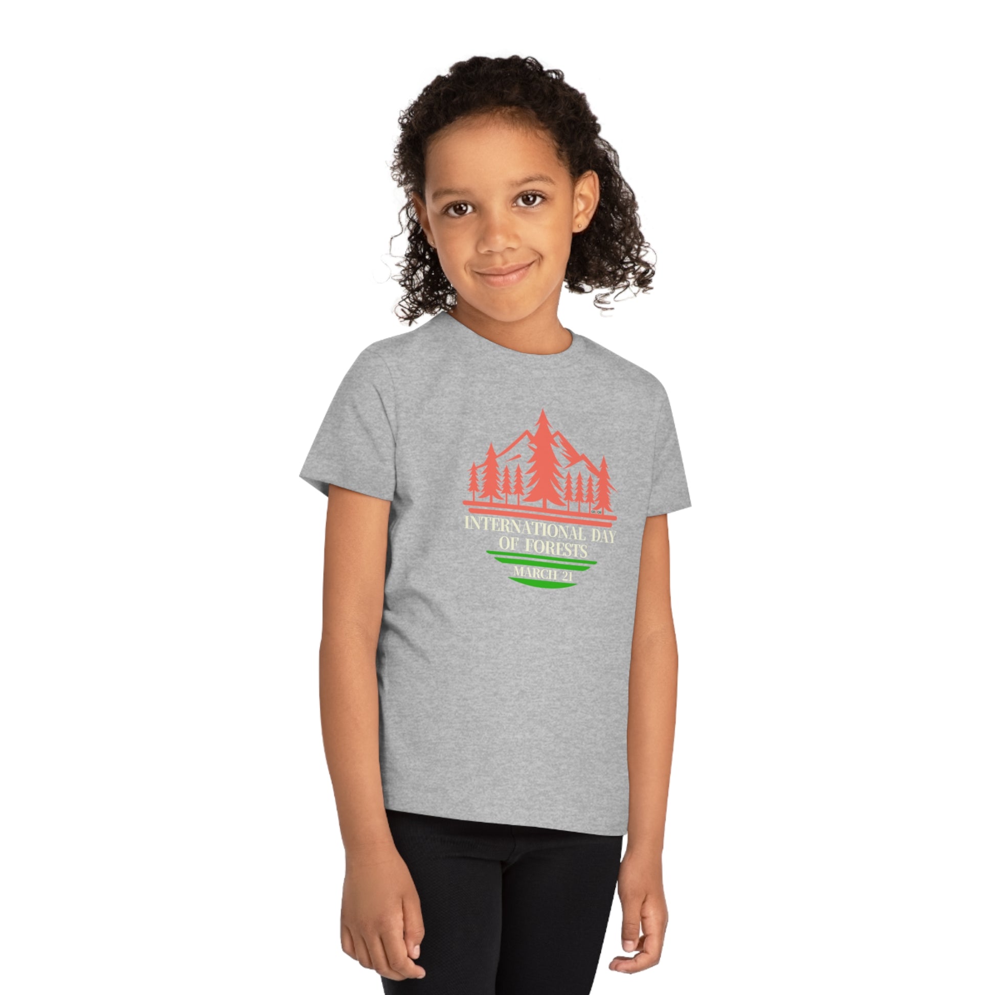 International Day of Forests, Child wearing a GR@ON Kids T-Shirt made from organic cotton, featuring a fun and colorful design. GR@ON Kids T-Shirts: Sustainable style, fun designs.