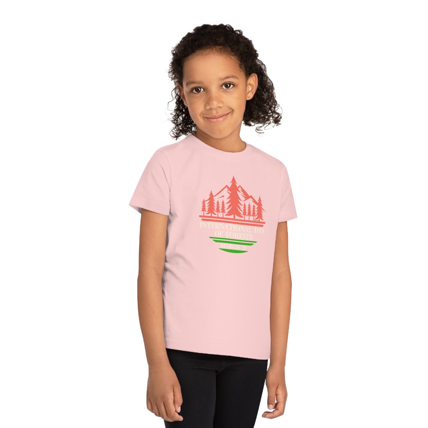 International Day of Forests, Child wearing a GR@ON Kids T-Shirt made from organic cotton, featuring a fun and colorful design. GR@ON Kids T-Shirts: Sustainable style, fun designs.