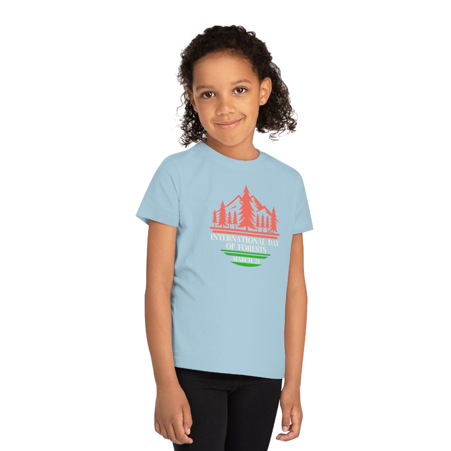 International Day of Forests, Child wearing a GR@ON Kids T-Shirt made from organic cotton, featuring a fun and colorful design. GR@ON Kids T-Shirts: Sustainable style, fun designs.